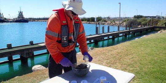 Person collecting core sediment samples